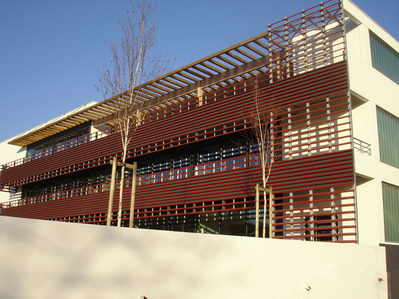 Établissements Bouney à Anglet : façade des bureaux à lames de red cedar et pergola.